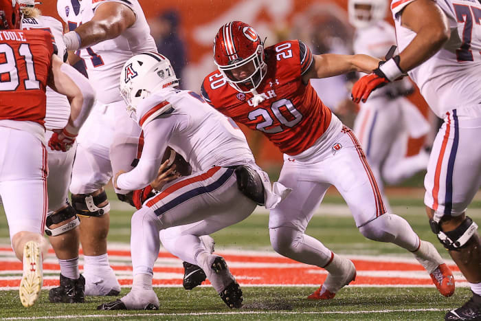 Nov 5, 2022; Salt Lake City, Utah, USA; Arizona Wildcats quarterback Jayden de Laura (7) is tackled by Utah Utes linebacker Lander Barton (20) in the third quarter at Rice-Eccles Stadium. Mandatory Credit: Rob Gray-USA TODAY Sports
